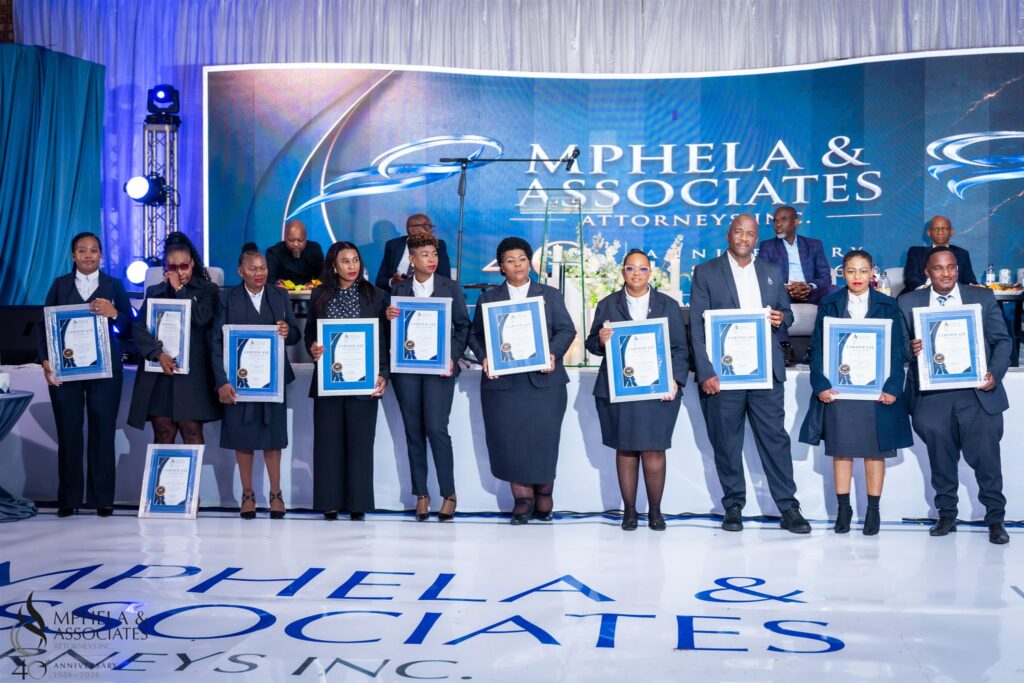Award recipients standing together with their certificates at Mphela & Associates Attorneys’ 40th anniversary ceremony